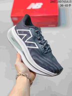 Side view of the running shoe showing the large New Balance logo, patterned upper and white midsole.