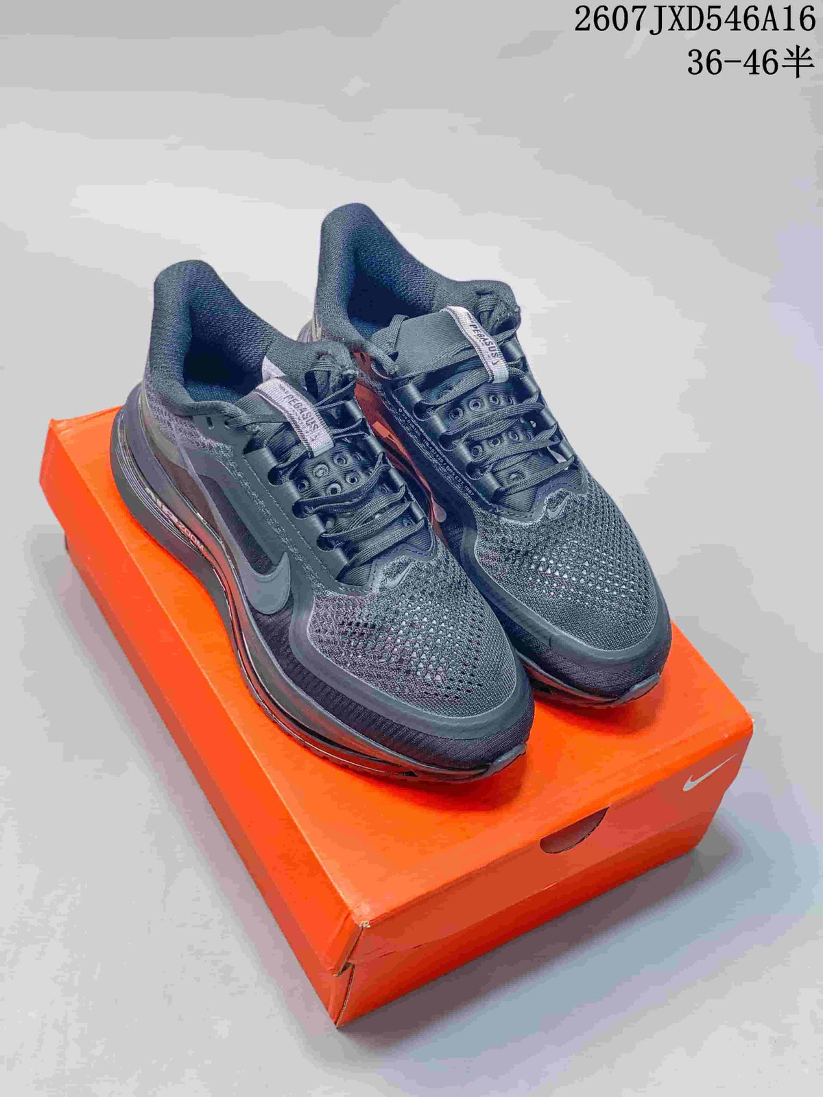 Pair of black and gray Nike Zoom sneakers displayed on an orange shoebox.