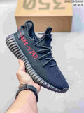 Dark Adidas Yeezy-style sneaker with a textured upper, red side lettering and a ridged sole.