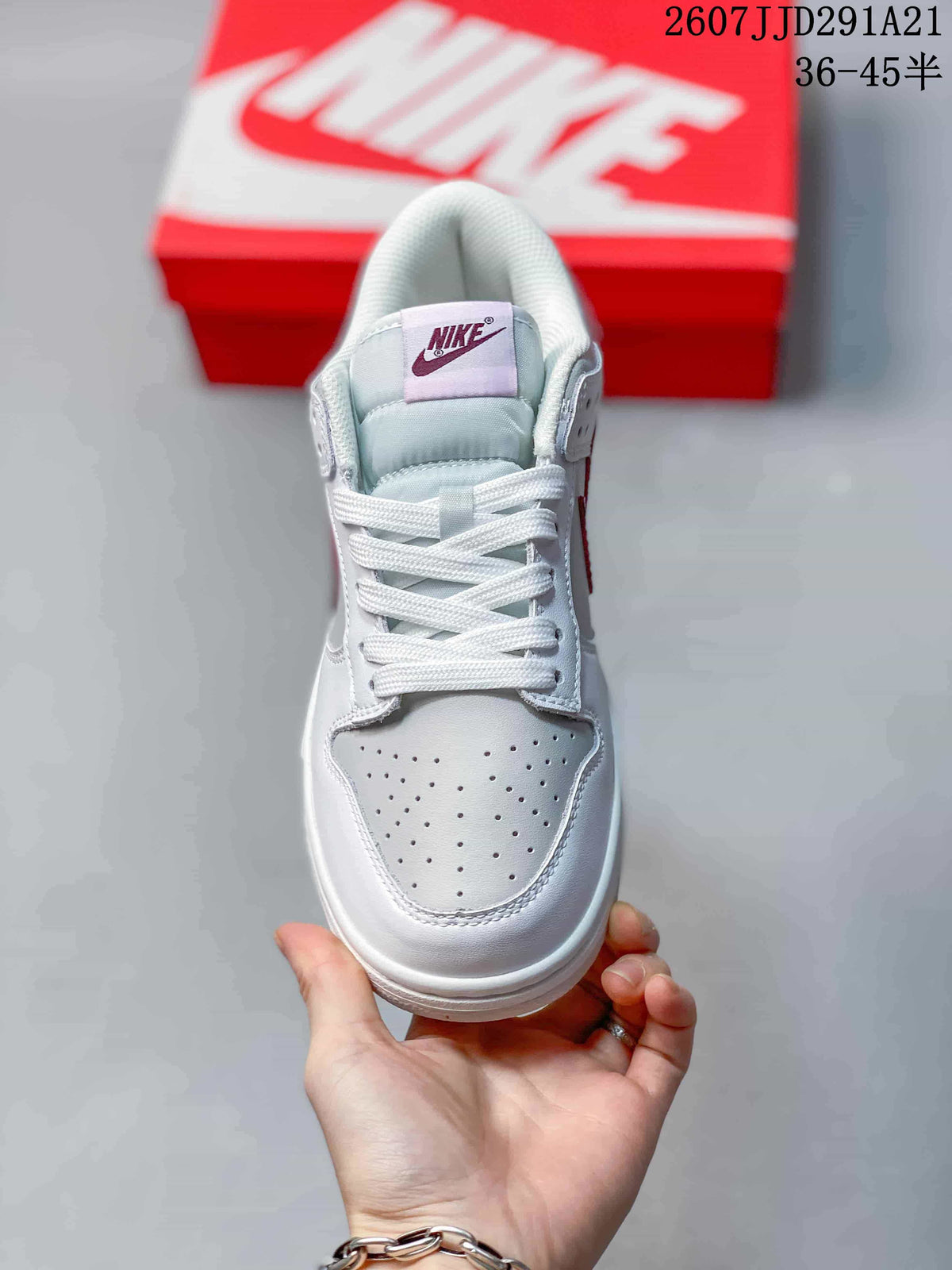 Front view showing the white laces, perforated toe box, padded tongue, and contrasting red tongue label.