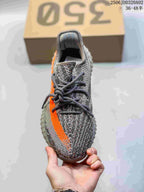 Top view showing the gray knit-look upper, dark laces, and orange side stripe.
