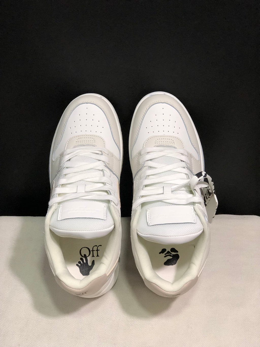 Top view showing the perforated toe boxes, white laces, tongue panels, and printed insoles.