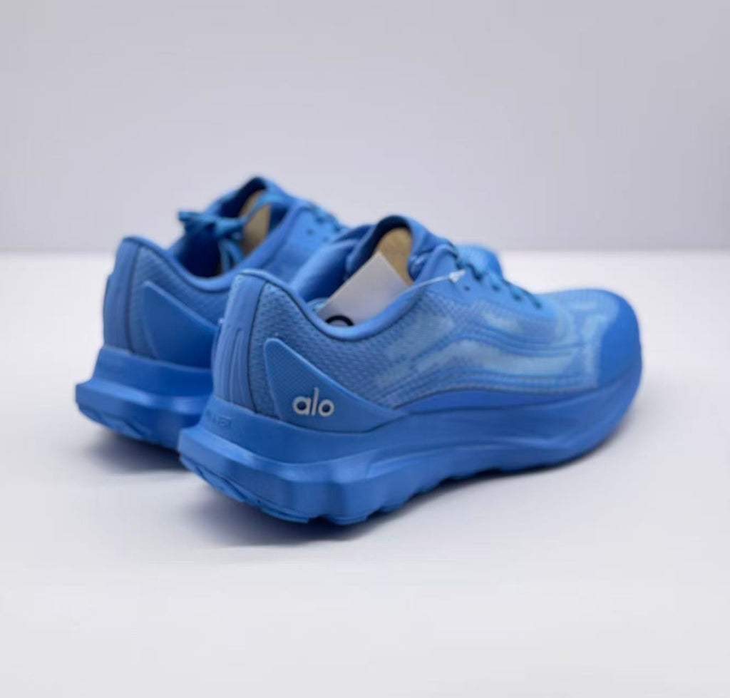 Rear three-quarter view of the blue sneakers showing the padded collars and heel branding.