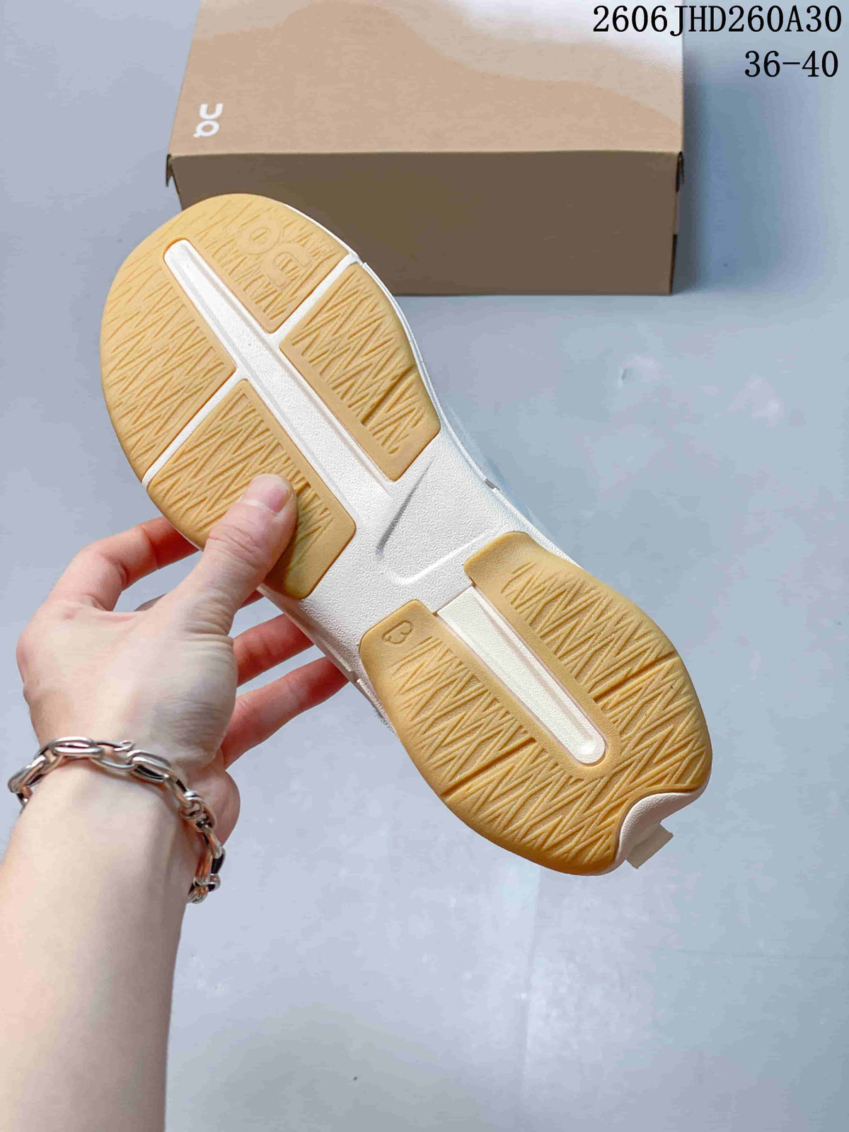 Underside of a Cloudnova Moon sneaker showing its gum-colored tread