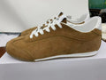 Side view of brown Alo low-top sneakers with white laces, white collar accents, and a white midsole.