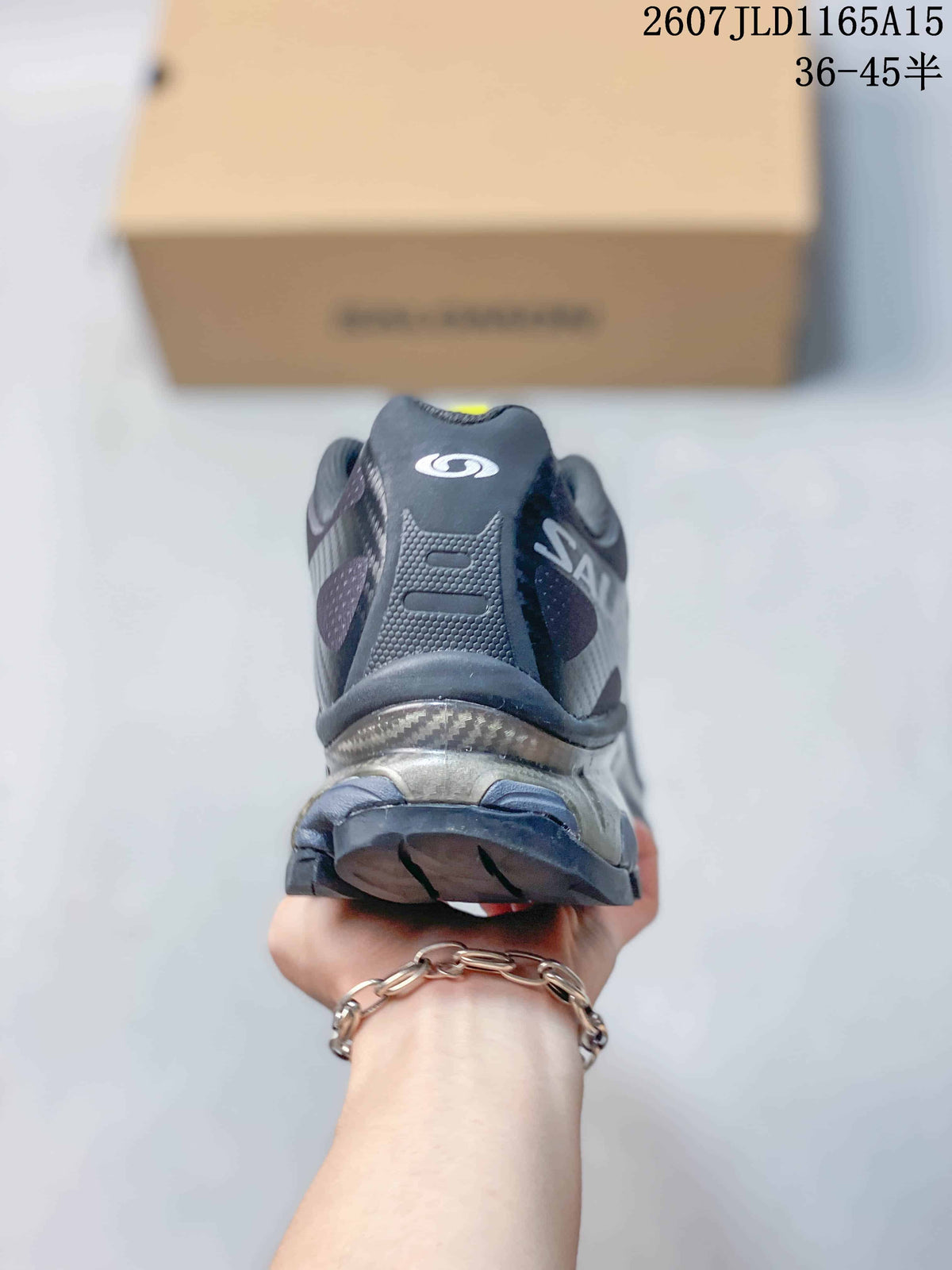 Rear view of the black sneaker showing the padded heel, Salomon branding, and textured outsole.