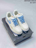 Pair of white Nike low-top sneakers with light blue accents and gold-toned branding displayed on a shoebox.
