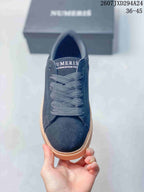 Top view of the sneaker showing tonal laces, a rounded toe, and Numeris branding on the tongue.