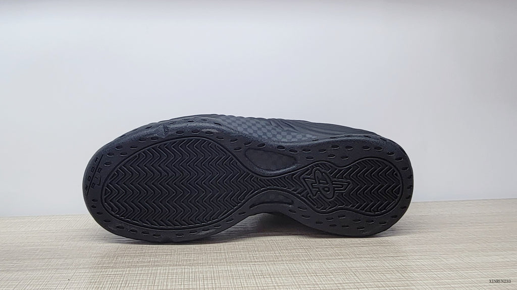 Bottom view showing the dark patterned outsoles of the sneakers.