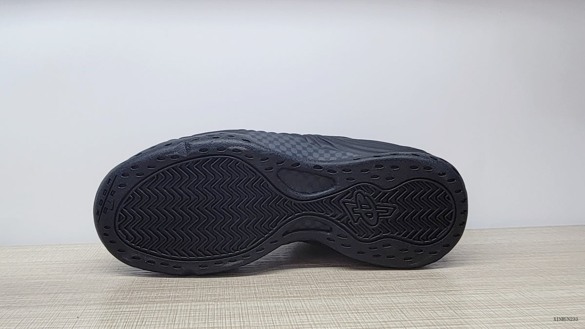 Bottom view showing the dark patterned outsoles of the sneakers.