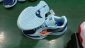 Blue and black low-cut basketball shoes with light blue laces and a patterned outsole