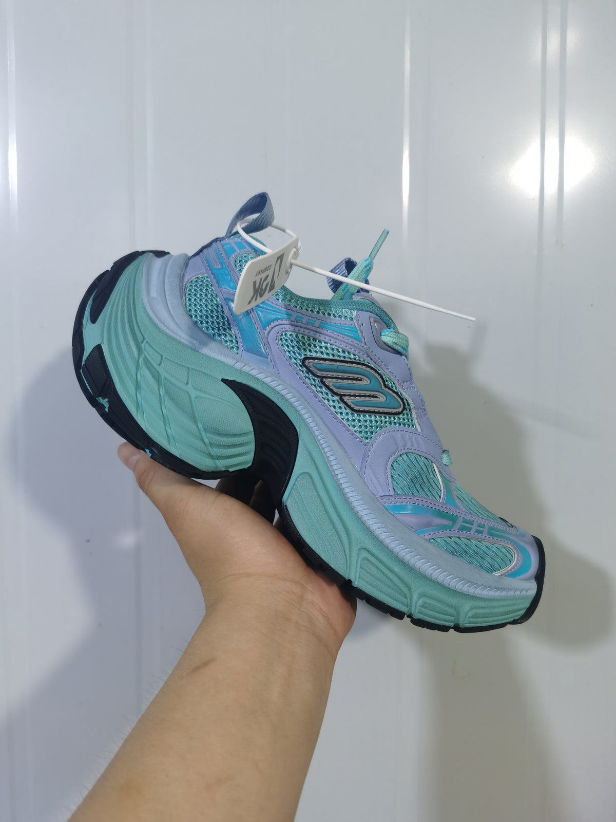 Close-up angled view of blue, teal, and lavender Skechers 4410 sneakers showing mesh panels, layered overlays, and a sculpted sole.
