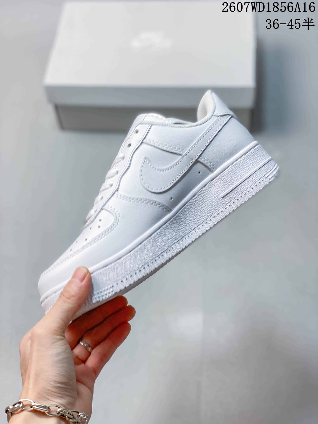 Side profile of the white low-top sneaker showing the Swoosh-style side detail, stitched panels, padded collar, and raised sole.