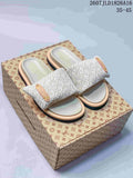 Pair of ivory Louis Vuitton Pool Pillow slide sandals displayed on a patterned box; style code 2607JLD1826A16 and size range 35–45 are visible.