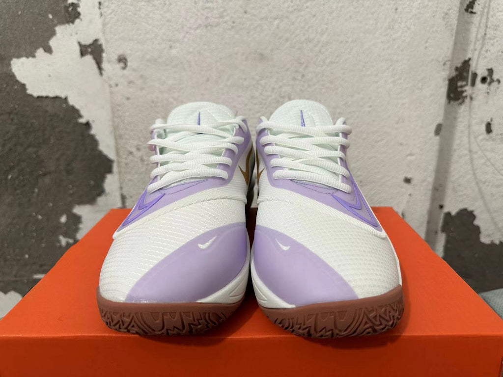 Front view showing the white laces, light purple overlays, and brown-toned outsoles