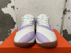 Front view showing the white laces, light purple overlays, and brown-toned outsoles