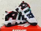 Pair of white and black sneakers with oversized side lettering and visible cushioning.