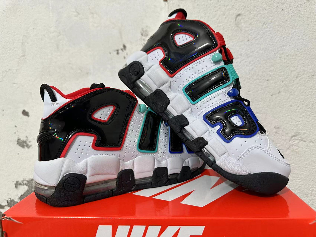 Pair of white and black sneakers with oversized side lettering and visible cushioning.