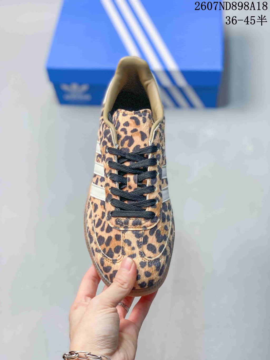Top view showing the leopard-print toe box, tongue, and black lace system.