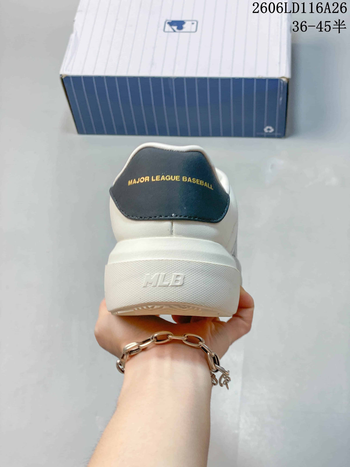 Rear view of the white sneaker showing the dark heel panel with Major League Baseball text and embossed MLB branding.