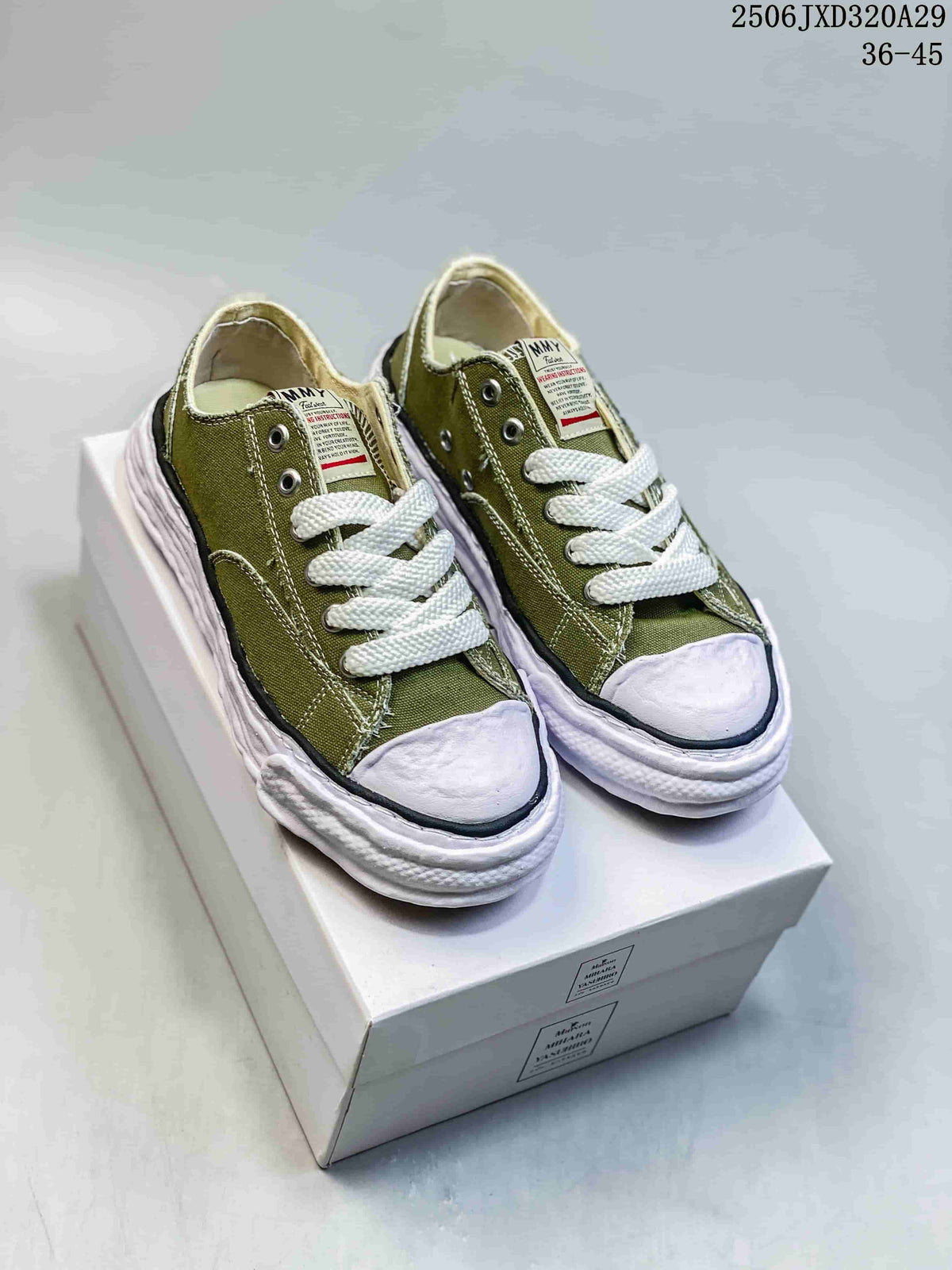 Pair of olive MMY Blakey sneakers displayed on a shoebox, showing white laces and sculpted white soles; size range text 36-45 is visible.