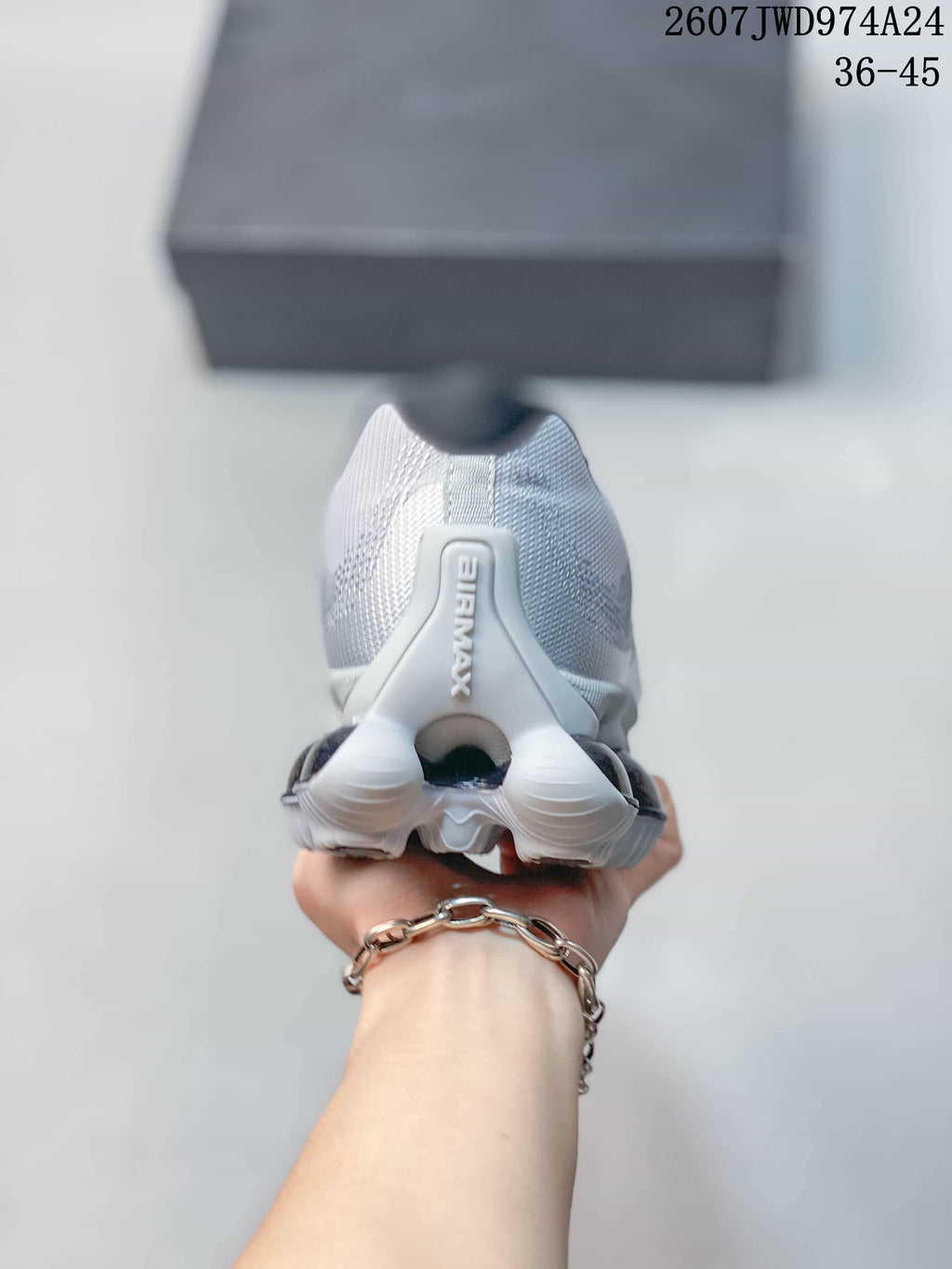 Rear view of a silver-gray and white Nike Air Liquid Max sneaker showing the heel structure and outsole segmentation.