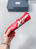 Side profile of the red shoe showing the white side stripes, lace-up upper, low-profile black outsole, and rounded toe.