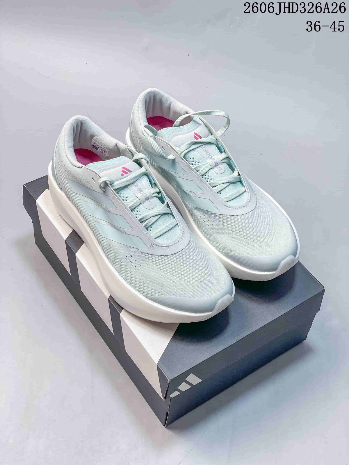 Pair of pale blue adidas Supernova Rise 3 running shoes displayed on a shoebox