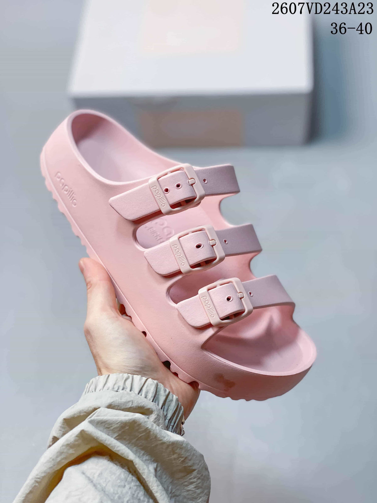 Pink Papillio three-strap sandal held against a light background, with the product code and EU size range shown at the top.