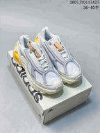 Pair of white, light gray, and yellow adidas low-top sneakers displayed on an adidas shoebox; overlay text shows style code 2607JYD117A27 and sizes 36–40.5.