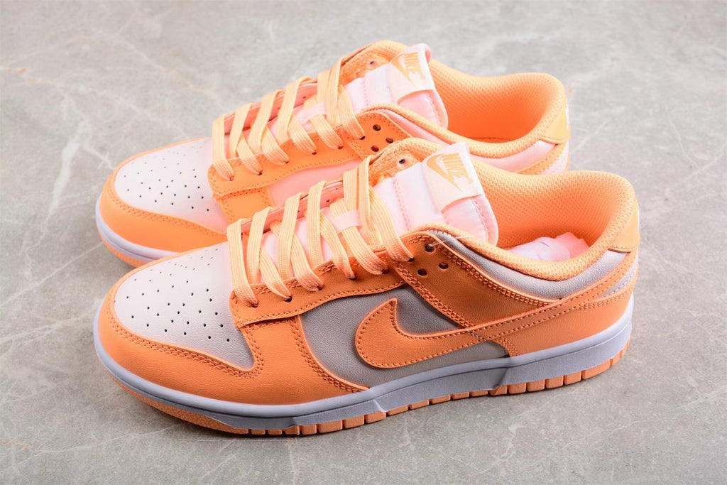 Top angled view showing the orange and light gray color blocking, laces, and perforated toe boxes.