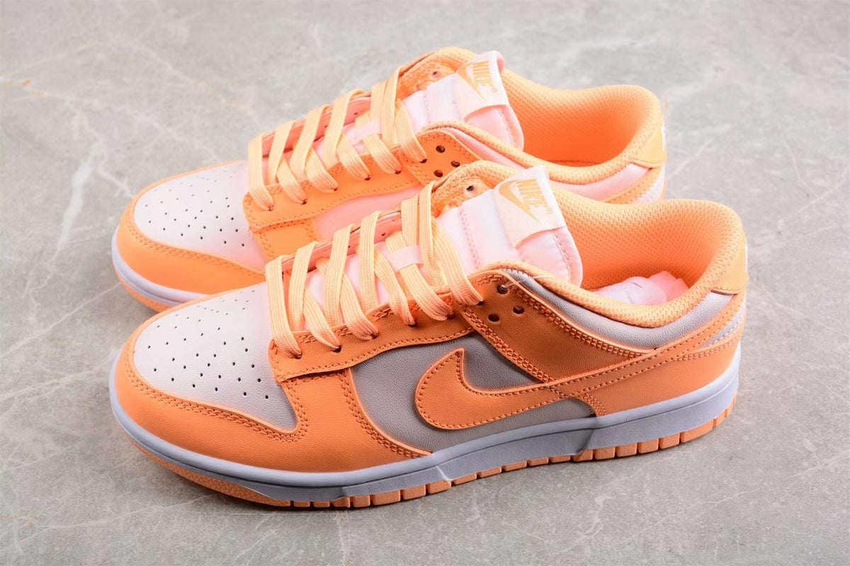 Top angled view showing the orange and light gray color blocking, laces, and perforated toe boxes.
