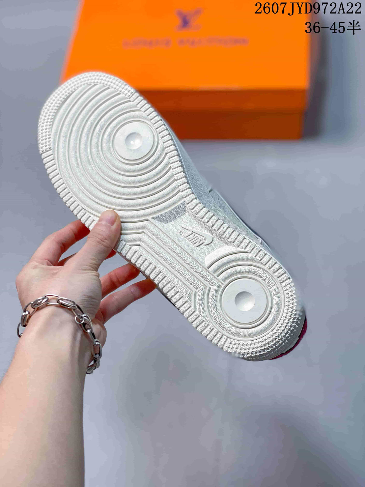 Close view of the white rubber outsole showing concentric circular traction patterns and molded Nike branding.