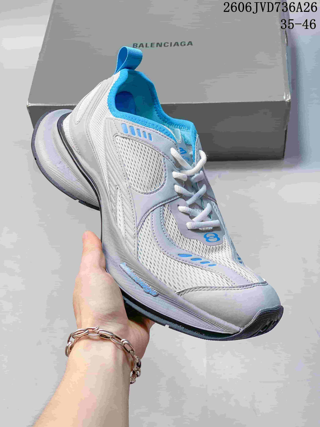White mesh sneaker with bright blue accents and a chunky sole
