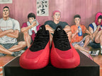 Front view of black and red Adidas high-top basketball shoes.