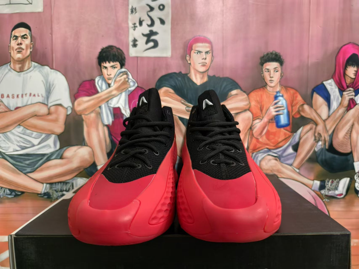 Front view of black and red Adidas high-top basketball shoes.