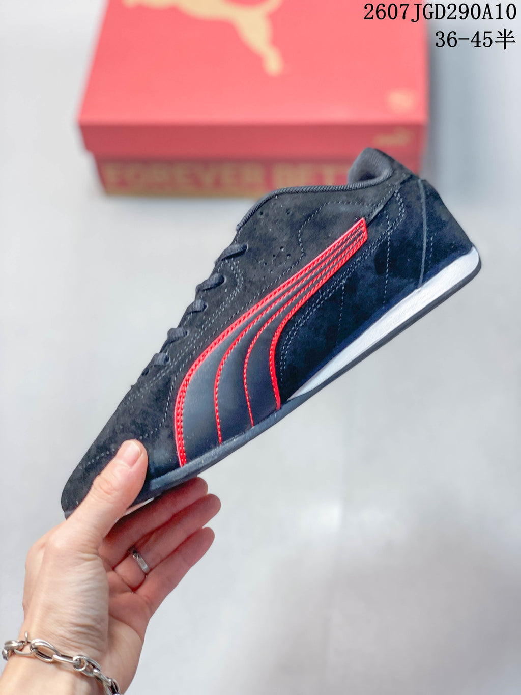 Side view showing the black upper, red Puma formstrip detailing, and low-profile white midsole.