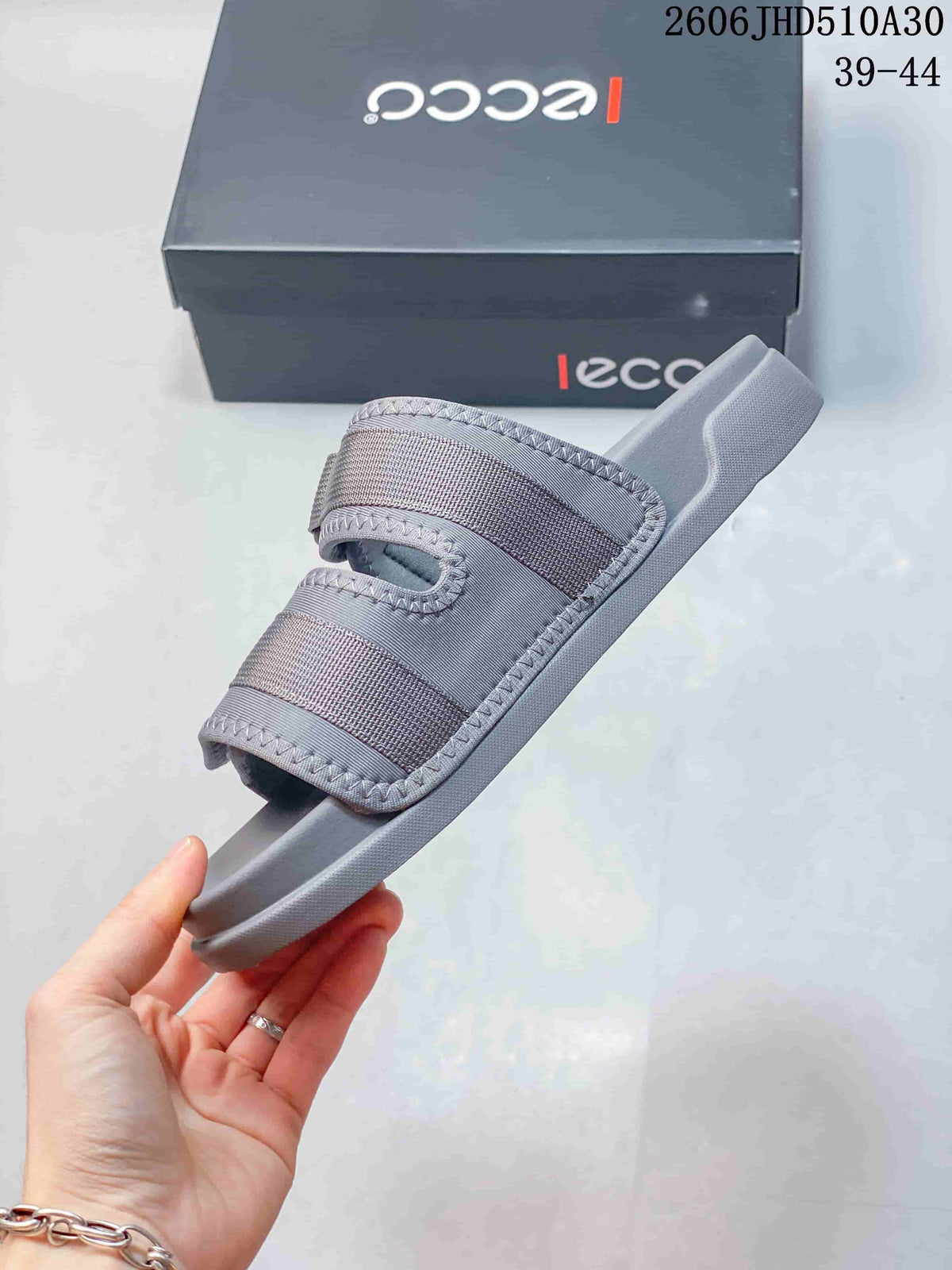 Side view of a grey ECCO sandal with two broad straps and an open toe
