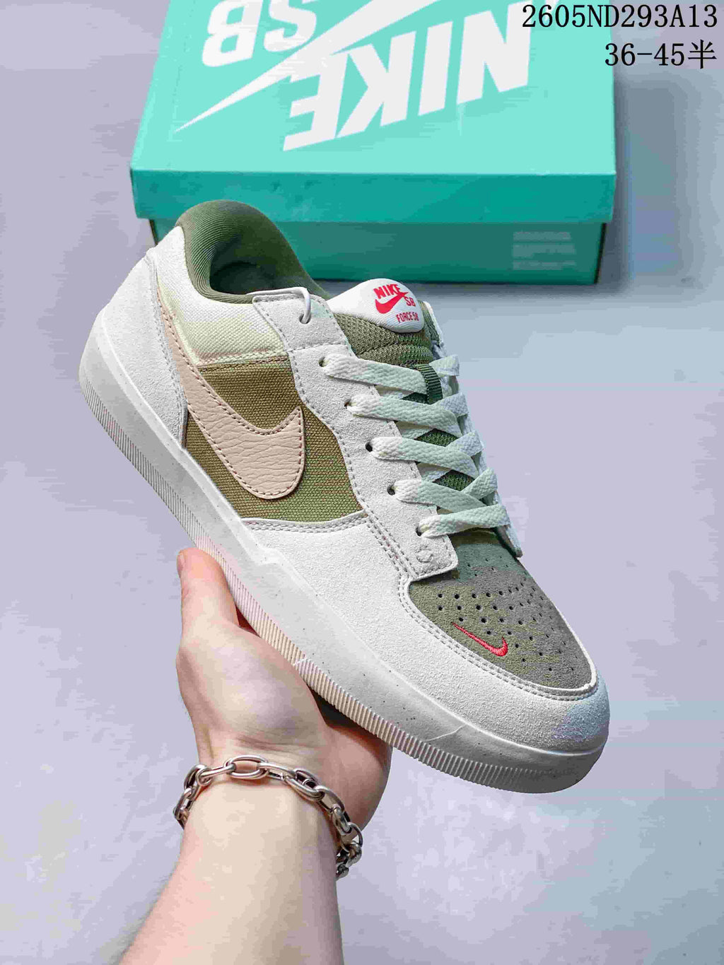 Angled side view highlighting the white and muted green color blocking, side branding, and low-top silhouette.