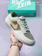 Angled side view highlighting the white and muted green color blocking, side branding, and low-top silhouette.