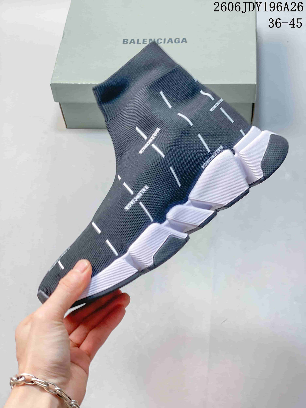 Side view of a dark navy Balenciaga sock sneaker showing the knit upper, white dash details, and segmented outsole.