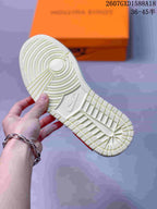 Close-up of the sneaker outsole showing a pale textured rubber tread with circular traction rings.