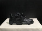 Side profile of a black low-top sneaker showing the lace-up upper, layered side detailing and segmented light outsole sections.