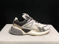 Side view of the off-white and grey AMIRI MA Runner sneaker with layered panels and a chunky outsole.