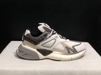 Side view of the off-white and grey AMIRI MA Runner sneaker with layered panels and a chunky outsole.