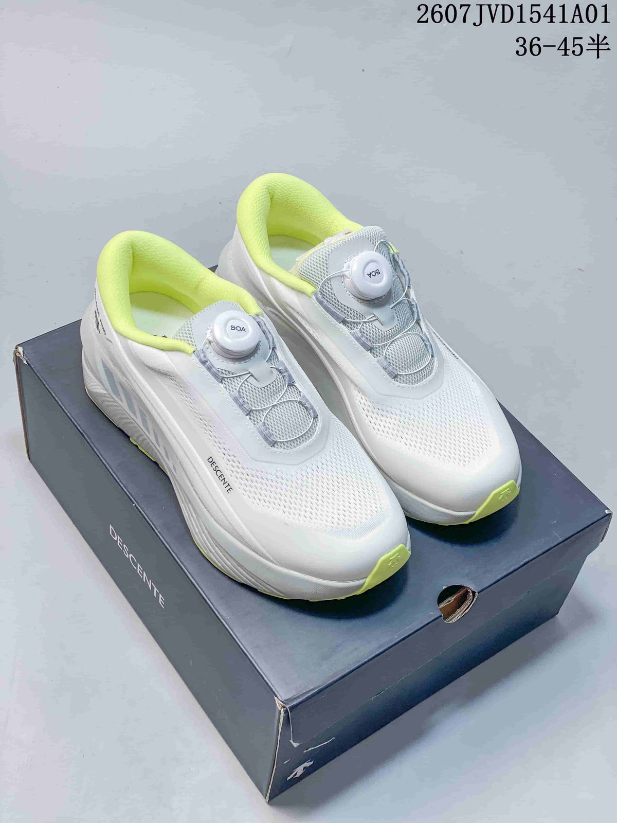 White Descente running shoes with bright lime accents and dial closures.