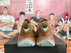 Rear view of brown Nike low-top sneakers showing patterned heel panels and mint-tone sole details.