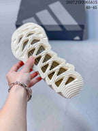 Close view of the sneaker outsole showing the sculpted tread pattern and open geometric sections, with style code JYD1065A15 and size range 40–45 visible.