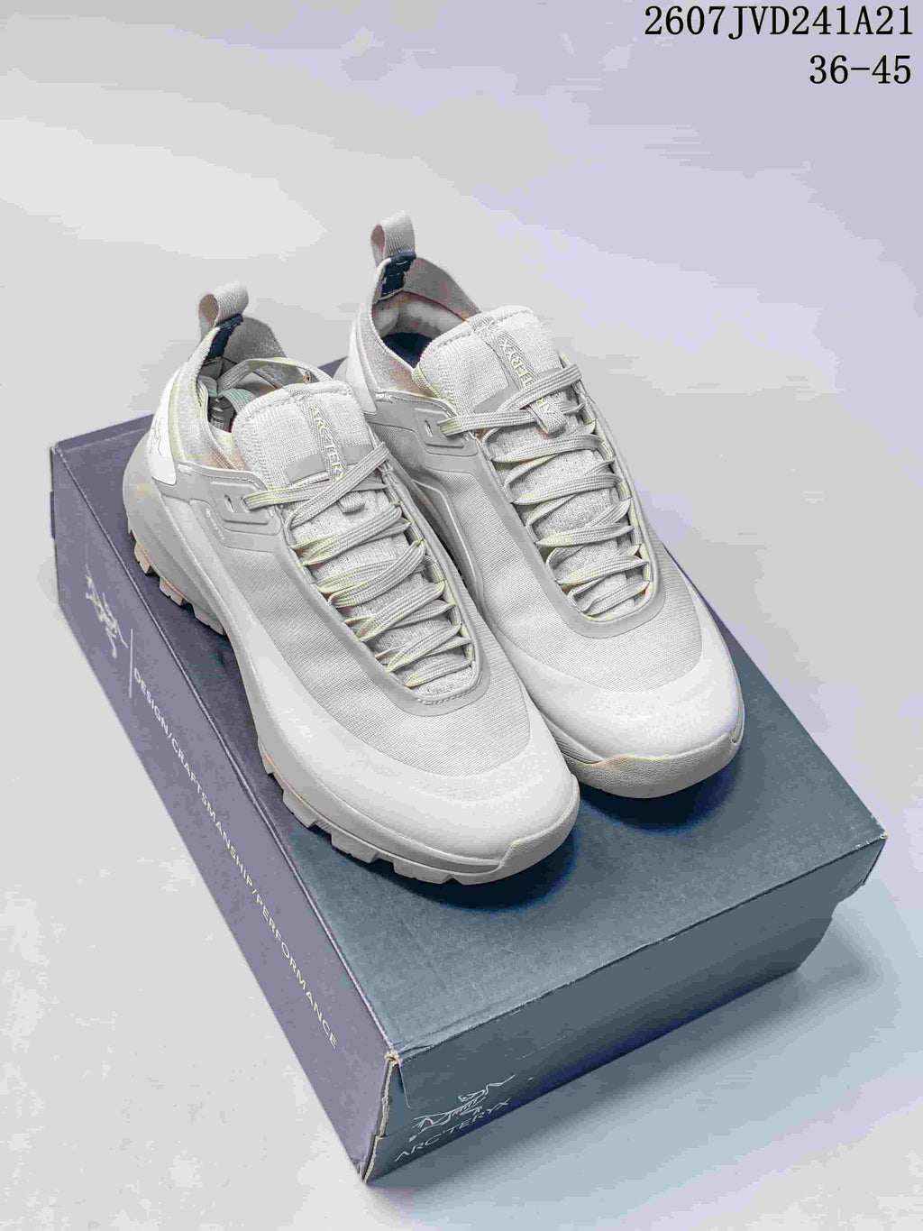Pair of light gray Arc'teryx Norvan LD 3 trail sneakers displayed on a shoebox.