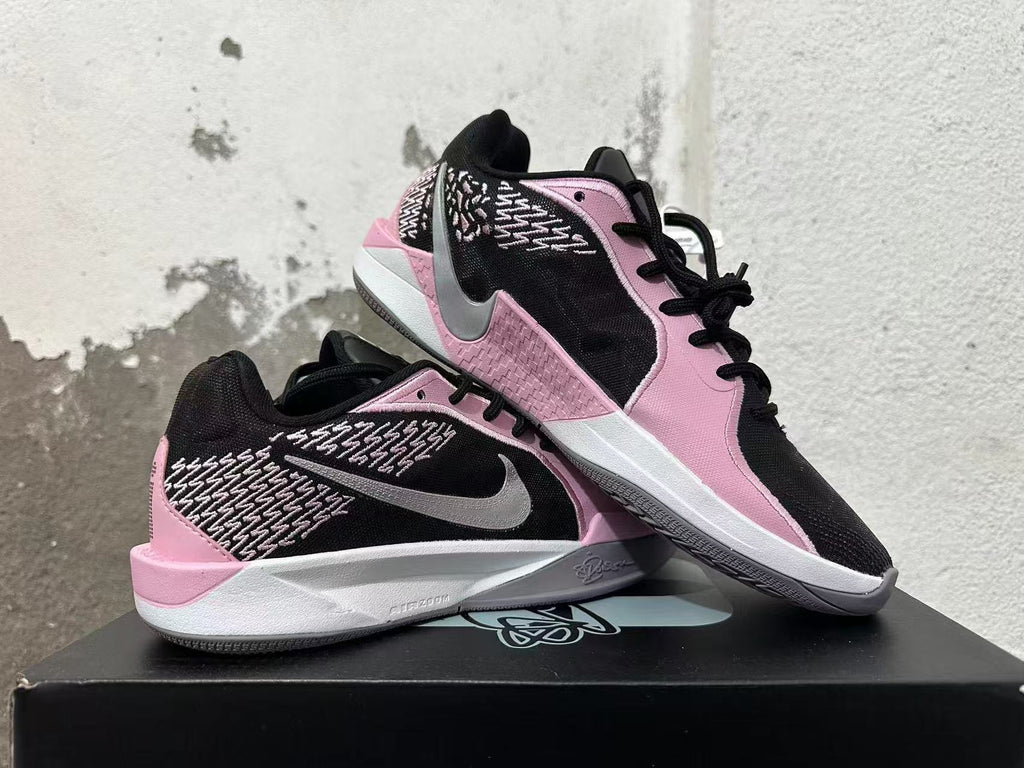 Pair of pink and black low-top basketball shoes shown from side and top angles.